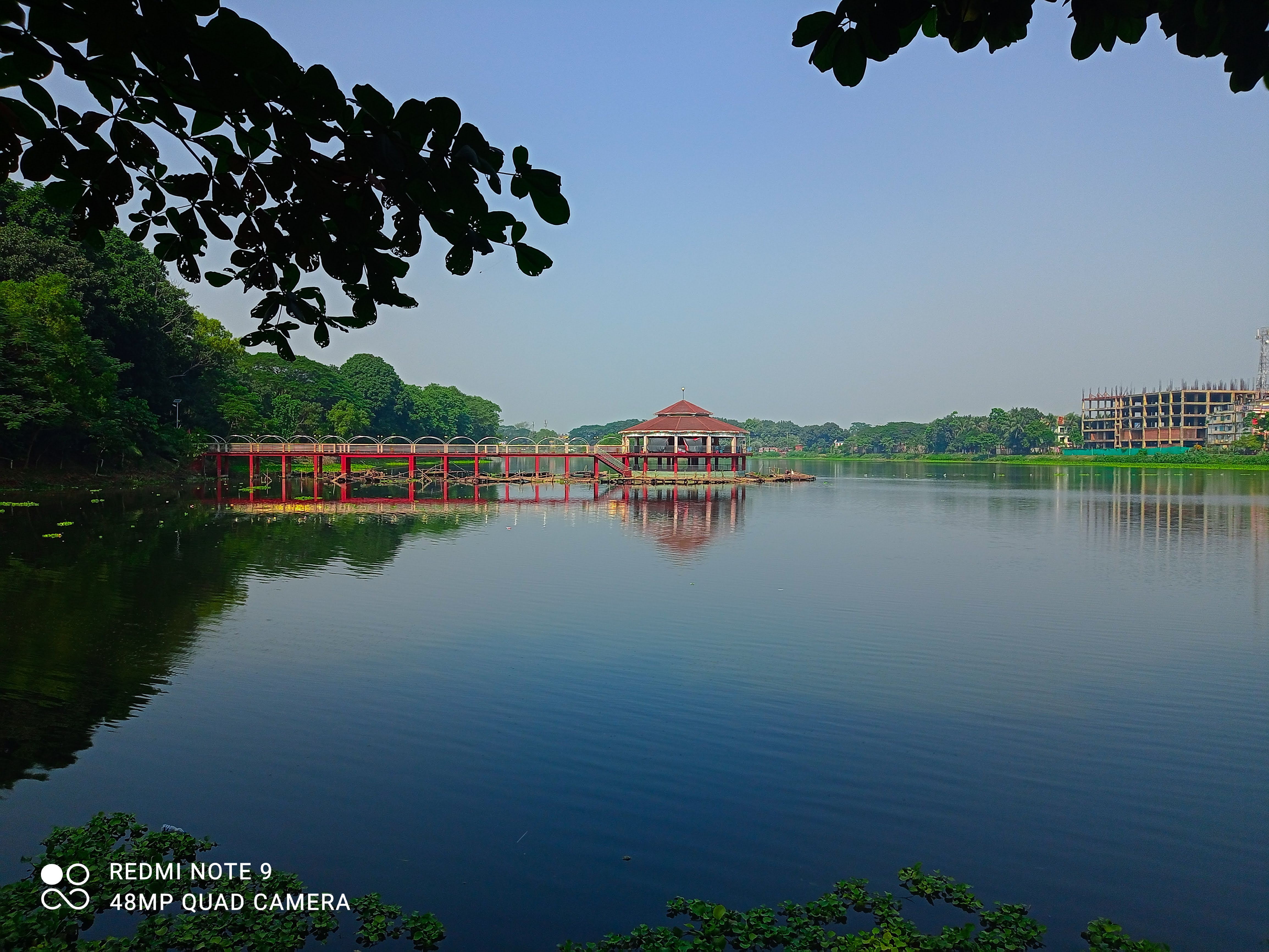 Red bridge and pavilion at DC Lake Tangail